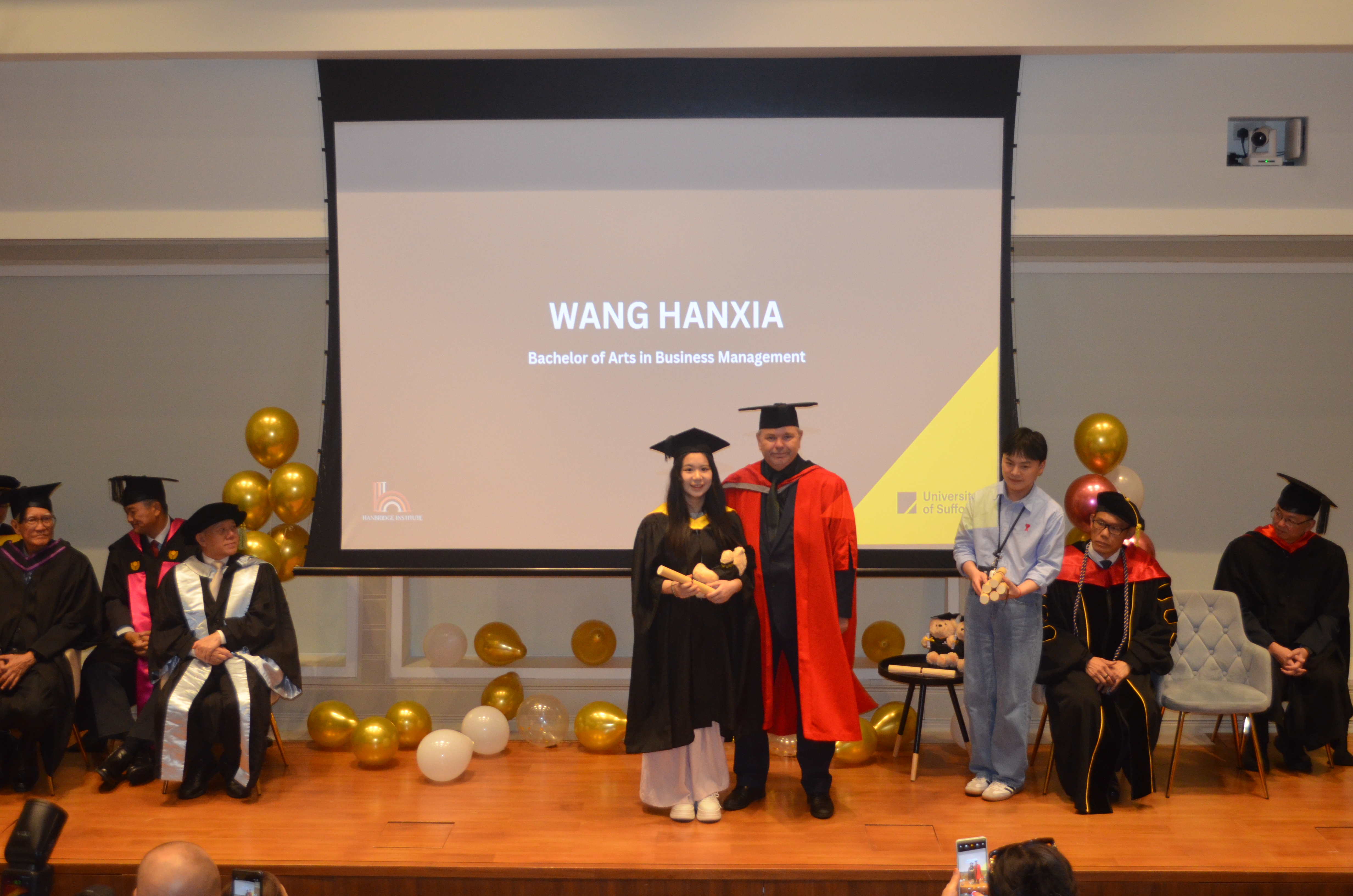 Graduate on stage at Hanbridge Institute