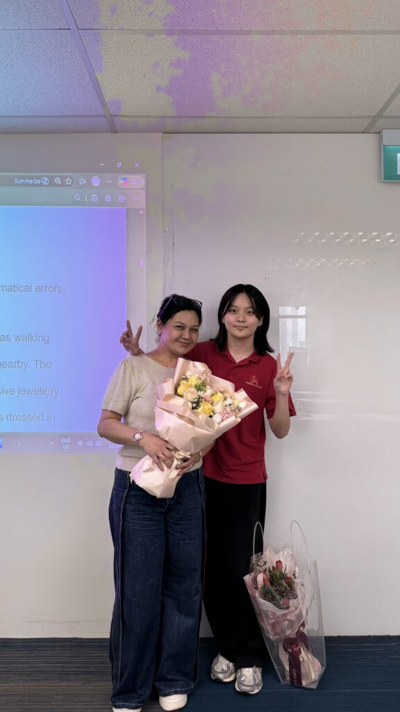 A grateful international student presenting flowers to a Hanbridge Institute teacher after successful S-AEIS results 2026.