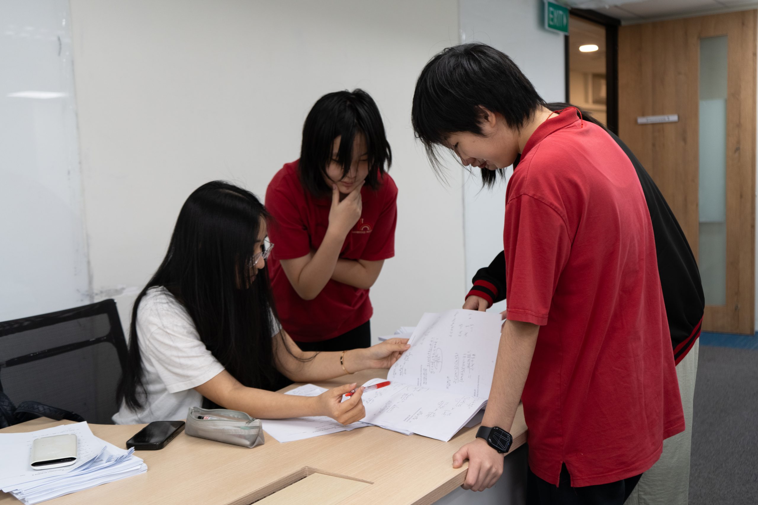 Group of international students happily participating in a timed math challenge at Hanbridge Institute