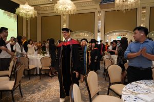 Hanbridge Institute students wearing academic gowns and mortarboards at their graduation ceremony