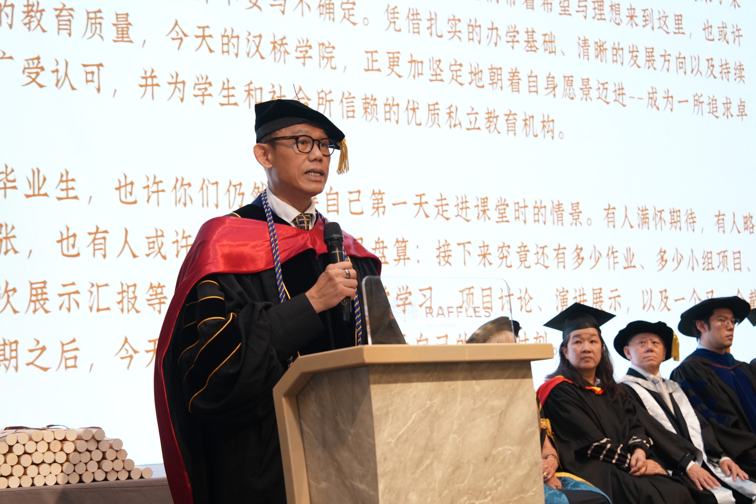 Dr Alan Go, Chairman of the Academic Board at Hanbridge Institute, addressing graduates and guests during the Graduation 2026 ceremony.