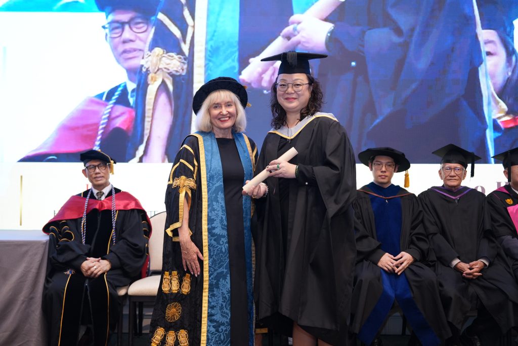 MBA graduate Cao Hui receiving her graduation certificate during Hanbridge Institute's 2026 ceremony