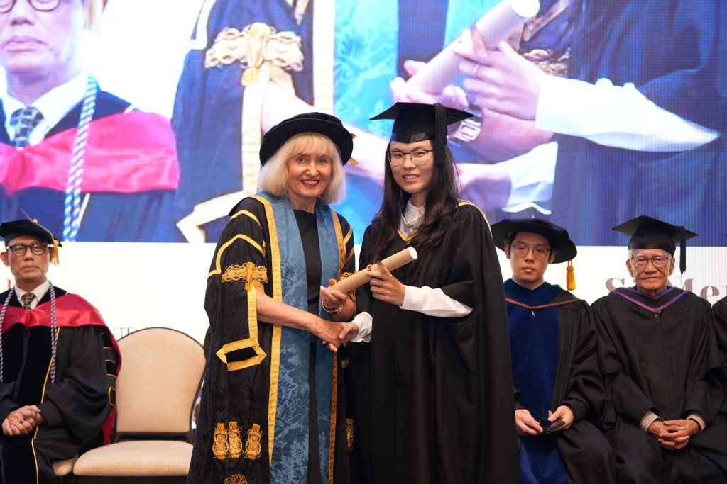 Professor Jenny Higham presenting University of Suffolk graduation certificates to Hanbridge Institute graduates