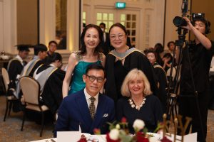 Hanbridge Institute graduates, staff and guests celebrating together after the graduation ceremony