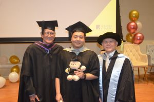 Dr Charlie Tay and Professor Richard posing with Hanbridge Institute graduates during the Graduation 2025 celebration