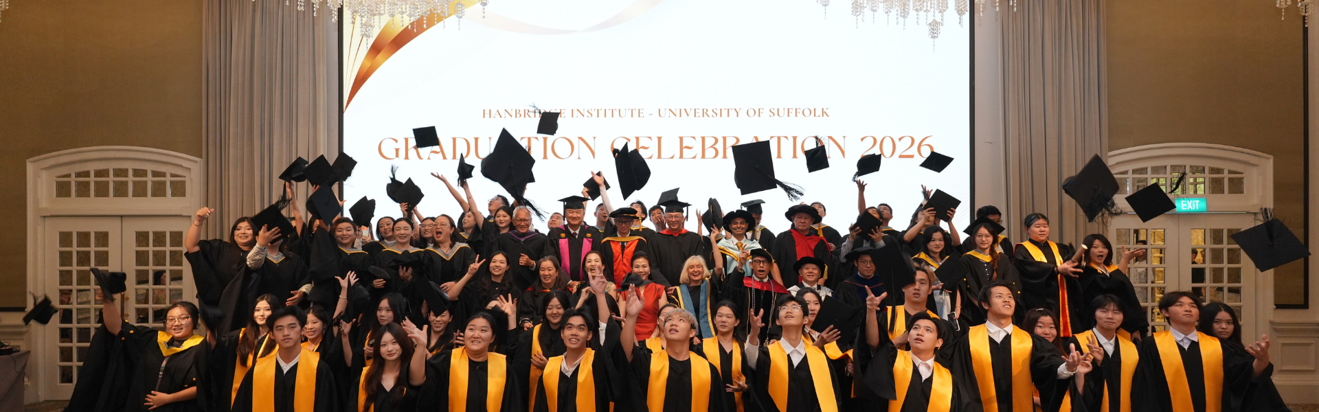 Hanbridge Institute graduates celebrating their academic achievements during a graduation ceremony in Singapore.